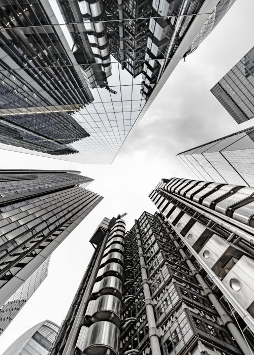 A vertical low angle shot of a modern business building scenery touching the sky